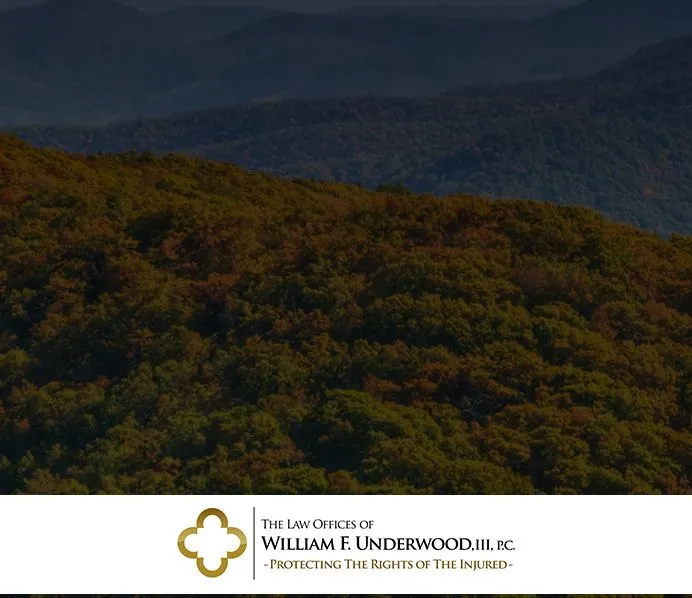 Aerial view of forested hills with a law office logo and text for William F. Underwood, III, P.C. at the bottom.