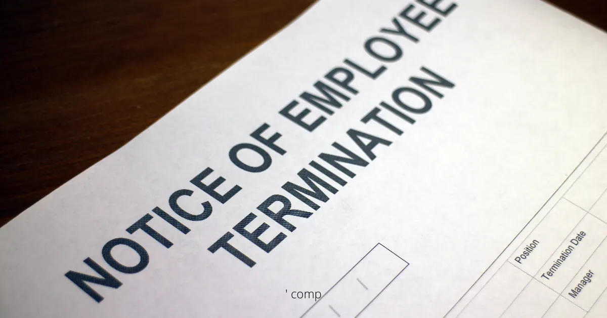 Close-up of a printed "Notice of Employee Termination" document on a wooden surface.